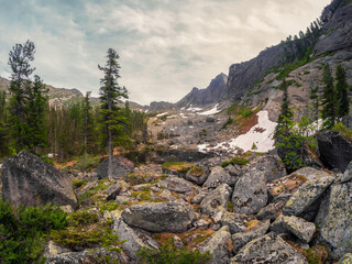 Mountain black lake in the block stream valley.