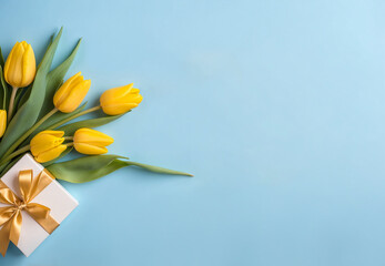 Holiday concept. top view of yellow tulips on isolated pastel blue background with copy space