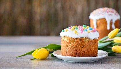 Easter cake, eggs and flowers on a wooden table. Selective focus