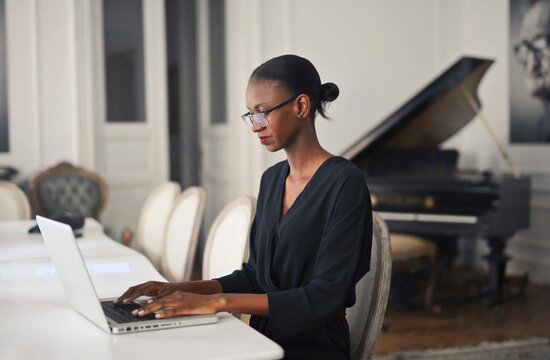 Young Beautiful Black Woman Works With Computer