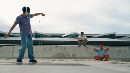 Group of skilled break dancer perform street dance with friend looking and cheering at him....