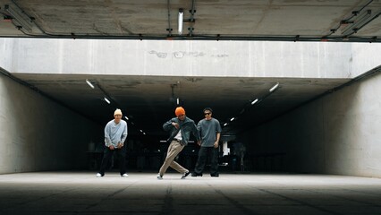 Panorama shot of hipster group dance together while perform b-boy dance. Street dancer team moving to hip hop music while doing freeze pose. Break dance, street dance. Outdoor sport 2024. Sprightly. - obrazy, fototapety, plakaty