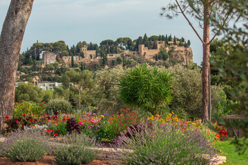 View of castle on top of a hill near the city center of Cassis, a beautiful and sunny seaside town with harbor. Provence region, southeastern France.