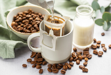 Drip coffee bag with ground coffee in  cup