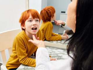 Male child in session with a speech therapist. Paediatric speech and language therapy