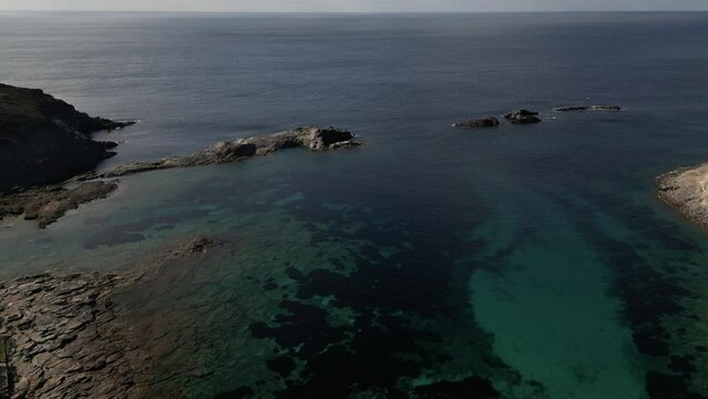 Aerial view of Cala Sapone, S. Antioco bay in Sardinia. Crystal clear sea, moored boat and white sand.