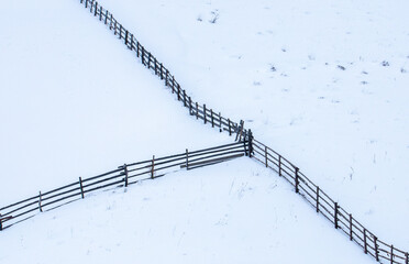 Wooden fences on a field covered with snow