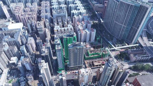 Aerial drone Skyview shot in Tsim Sha Tsui Whampoa Hung Hom commercial area, Hong Kong Victoria Harbour Financial Kowloon Peninsula and Central Wan Chai Causeway Bay