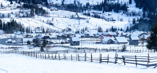 Landscape with a Romanian mountain village in winter. View from the Bukovina countryside