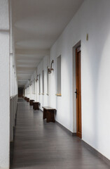 A long straight corridor with white walls