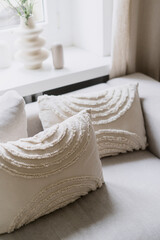 Fototapeta na wymiar Decorative cushion on comfort sofa in living room with scandinavian interior