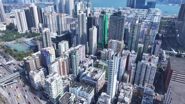 Aerial drone Skyview shot in Tsim Sha Tsui Whampoa Hung Hom commercial area, Hong Kong Victoria Harbour Financial Kowloon Peninsula and Central Wan Chai Causeway Bay