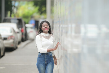 Fototapeta premium A young woman with his hairstyle and the atmosphere of living in the community.