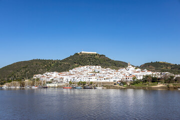 Fototapeta na wymiar Panoramic view of Sanlucar de Guadiana village in Huelva, Andalusia, on the banks of Guadiana river, in the border of spain with portugal, in front of the portuguese village of Alcoutim in Algarve