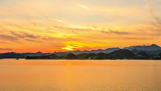 Beautiful lake and green mountains nature landscape at sunset. 4K Time lapse video.