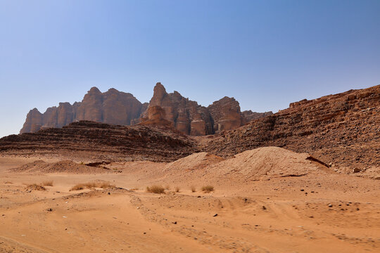 orange sand and rocky mountains on wadi rum desert