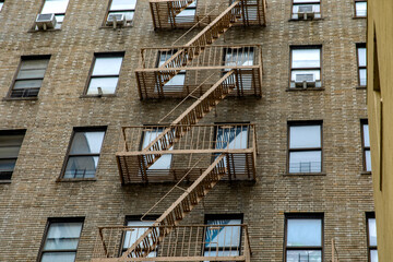 Facade of a typical brick building and emergency stairs in the Bronx neighborhood of New York City,...