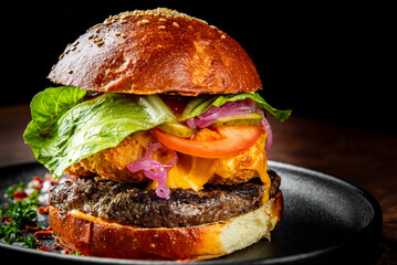 burger with meat, vegetables and cheese on table