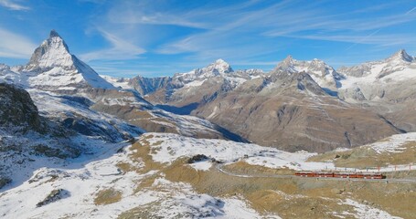Panoramic landscape of Gornergrat bahn railway climibing up the summit station with Matterhorn...