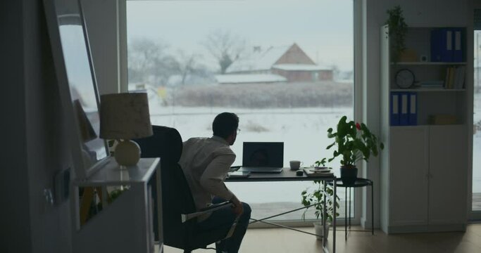 Businessman sitting on office chair at desk
