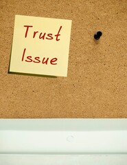 Note pinned on cork board with handwriting text TRUST ISSUE, haveing extremely difficult time...