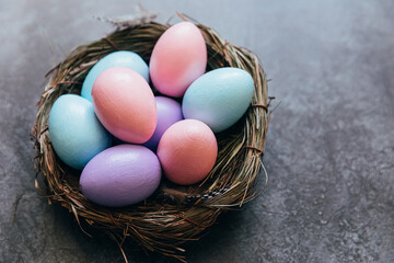 Happy Easter concept. Preparation for holiday. Colorful pastel decorated easter eggs in nest on...