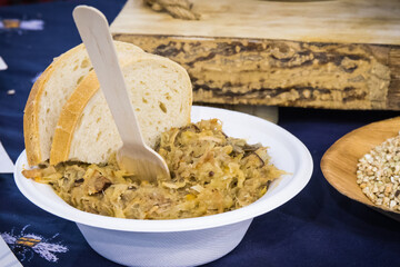 Traditional polish dish bigos and pieces of wheat bread