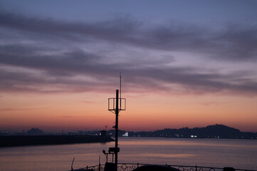 Scenery of a small port with a view of the dawn sky
