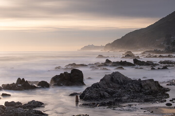 Beach with large rocks and waves
