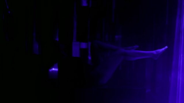 graceful woman moving legs seductively in darkness with bright laser rays, gorgeous delightful lady