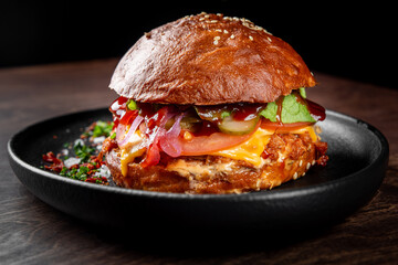 burger with meat, vegetables and cheese on table