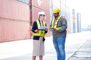 Engineers and employees working at a container warehouse.