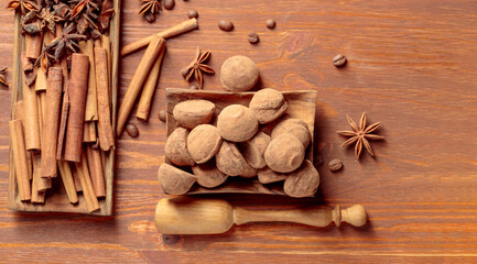 Chocolate truffles on a wooden table.