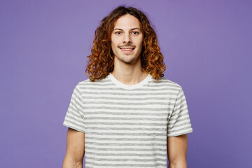 Young smiling fun happy satisfied positive man wears grey striped t-shirt casual clothes looking camera isolated on plain pastel light purple color wall background studio portrait. Lifestyle concept.