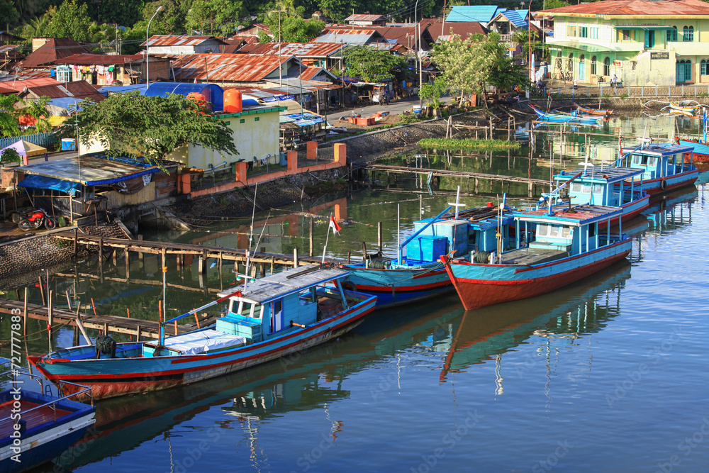 Poster Colorful blue and red fishing boats in the Batang Arau river and port in Padang City in West Sumatra, Indonesia.