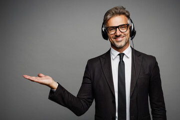 Adult employee operator business man wears black suit set microphone headset for helpline...