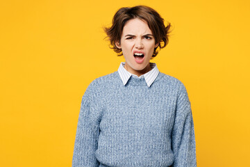 Young sad annoyed irritated outraged woman she wearing grey knitted sweater shirt casual clothes look camera with opened mouth isolated on plain yellow background studio portrait. Lifestyle concept. - obrazy, fototapety, plakaty