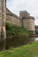 Fototapeta na wymiar moat and stonework of an aged medieval castle, the Chateau de Fougeres, France