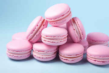 Stacked light pink macarons against a vibrant blue backdrop. Concept for bakery, dessert menu, or sweet treat promotion. Plenty of copy space.