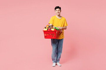 Full body young Caucasian man he wears yellow t-shirt casual clothes shopping hold in hand basket...
