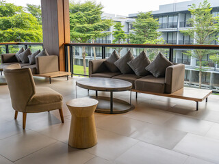 A Cozy Semi Outdoor Living Room with Sofa Sets, a Chair, and an Elliptical Coffee Table