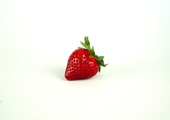 Red ripe strawberries lie on a white background