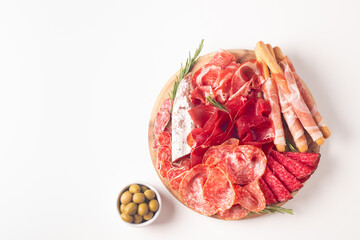 Charcuterie board. Antipasti appetizers of meat platter with salami, prosciutto crudo or jamon and olives.