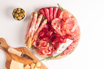 Charcuterie board. Antipasti appetizers of meat platter with salami, prosciutto crudo or jamon and olives.