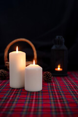 Burning candles and christmas decorations on a dark background