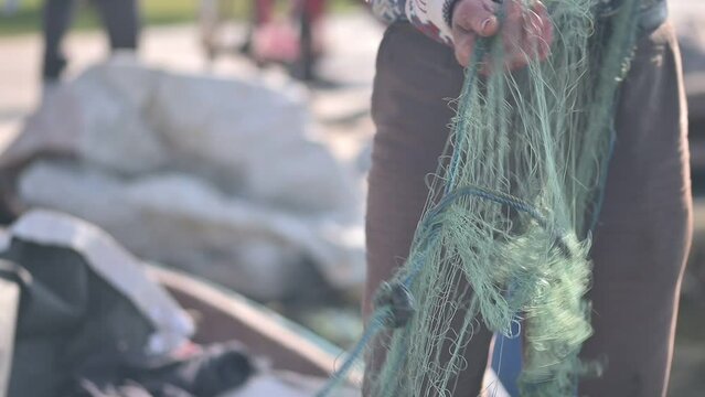 Fisherman Preparing Fishing Nets for Hunting
