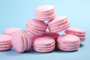 Fototapeta na wymiar Stacked light pink macarons against a vibrant blue backdrop. Concept for bakery, dessert menu, or sweet treat promotion. Plenty of copy space.
