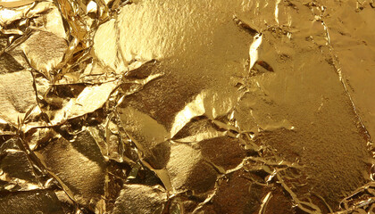 A textured surface of golden foil, gold texture background foil crumpled golden