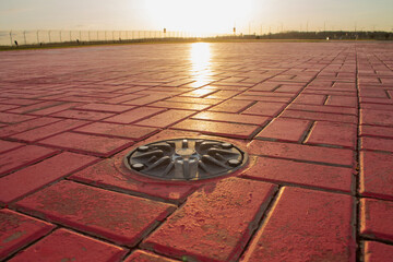 Helicopter pad. A red landing area for helicopters at sunset..Helipad landing lights. Illumination...