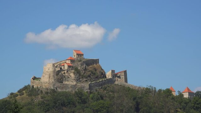 Timelapse of white cloud over Rupea Fortress in Romania